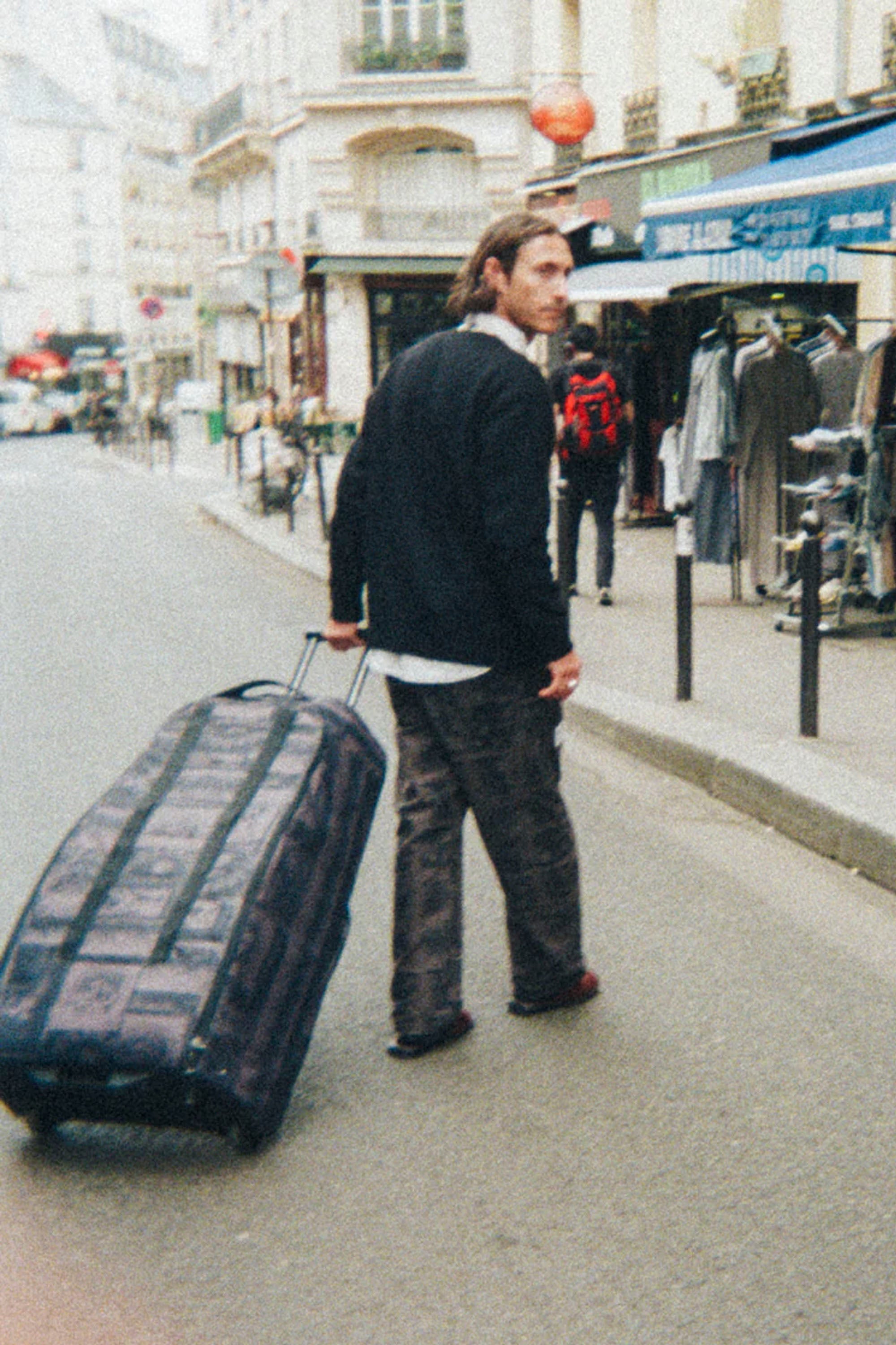 Large black surf travel bag featuring structured design and smooth-rolling wheels