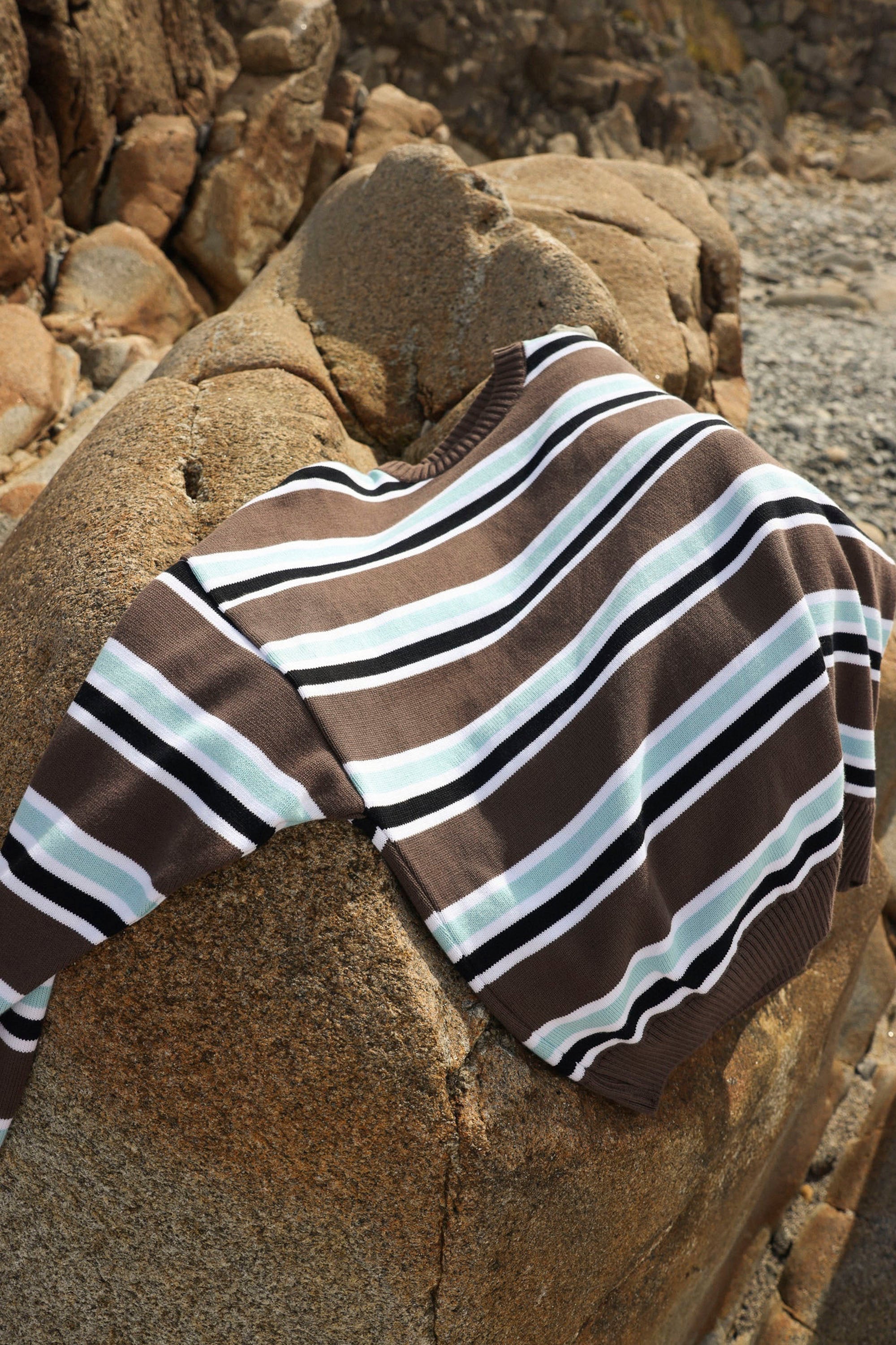 Nowhere Striped sweater on a rock Happylifeshops