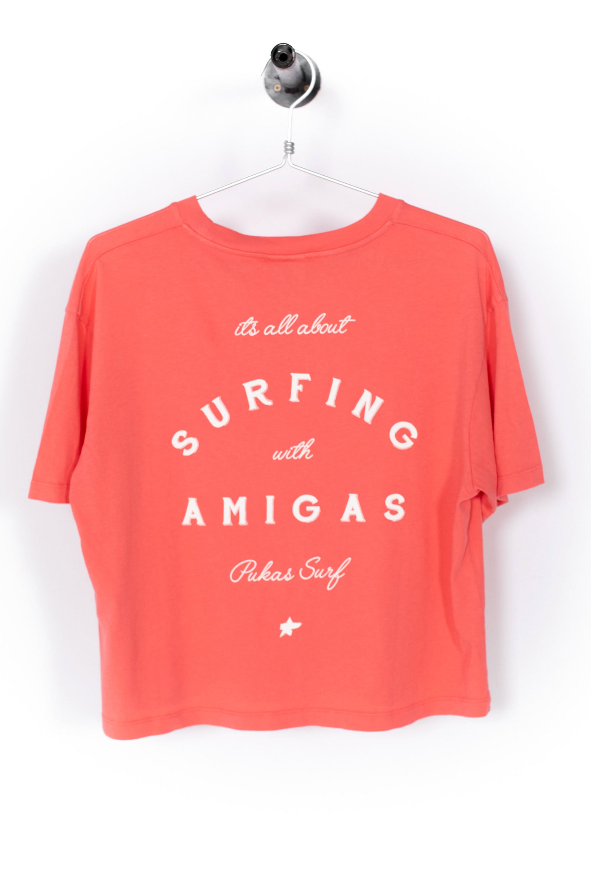 Coral t-shirt with white text on a white background