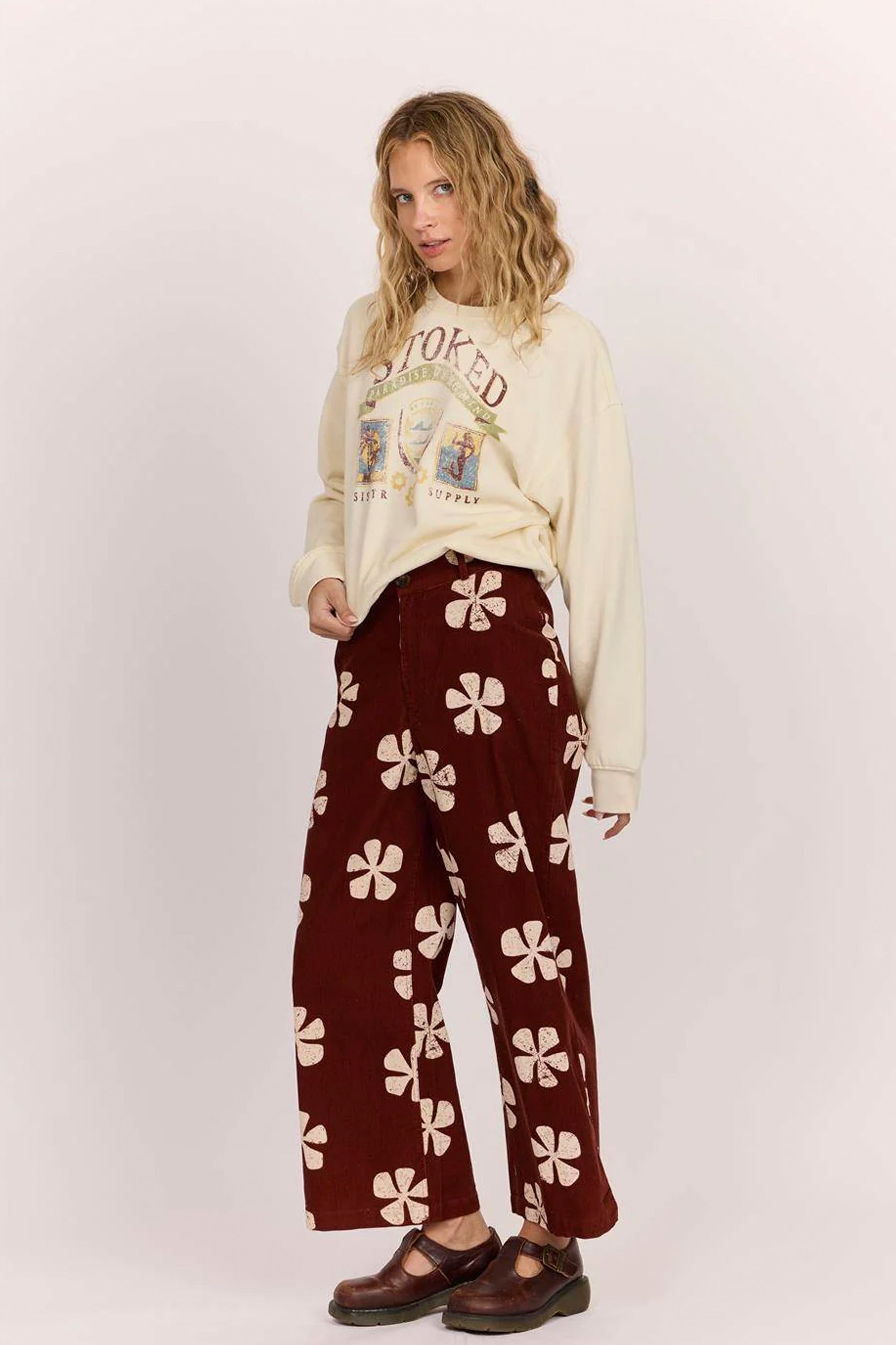 Sisstrevolution Happylifeshops Person wearing a cream sweatshirt with text and maroon pants