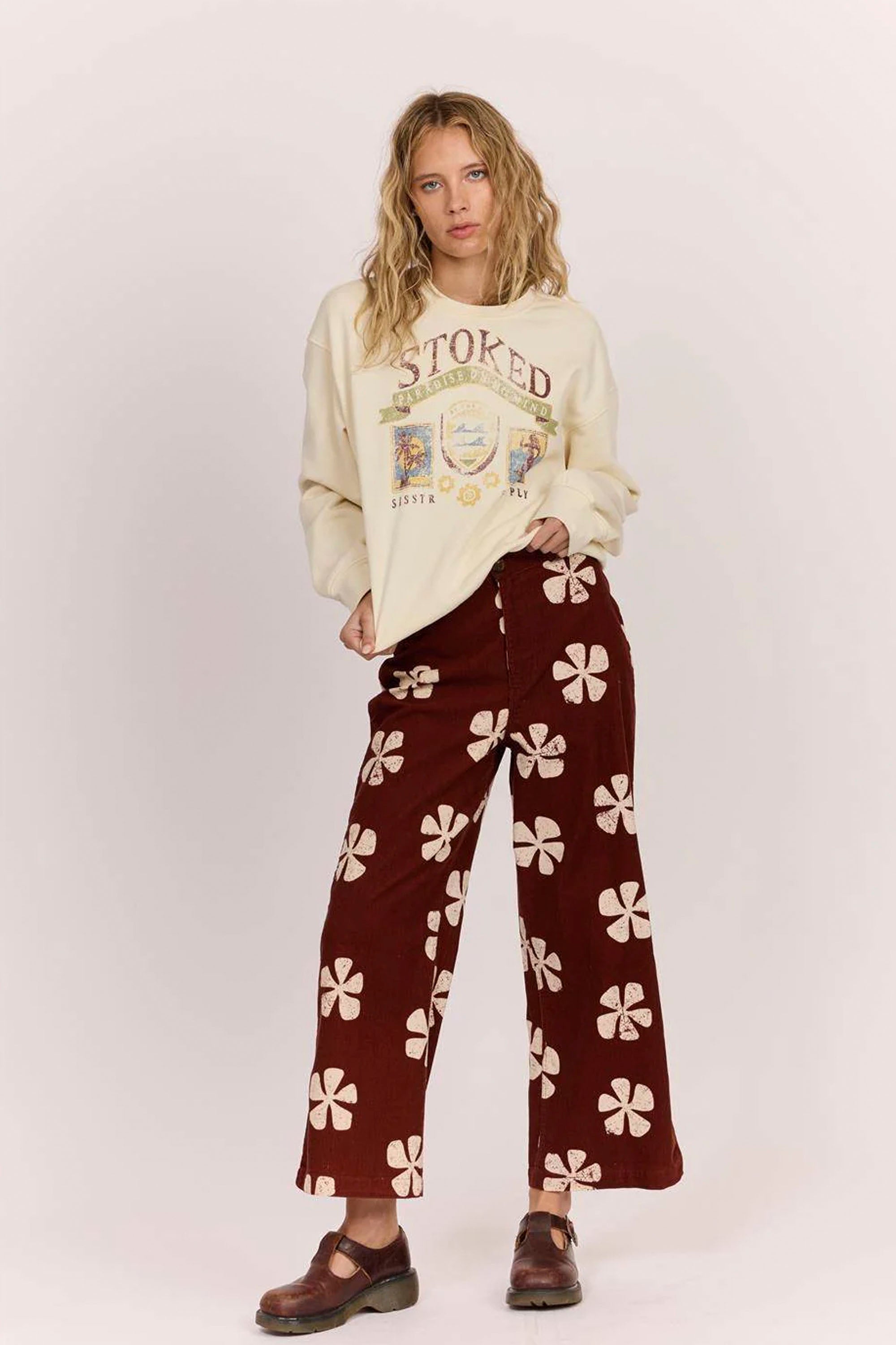 Sisstrevolution Happylifeshops Person wearing a cream sweatshirt with text and maroon pants